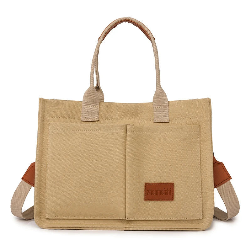 Premium canvas tote bag with multiple pockets, adjustable shoulder strap, and stylish design for everyday use