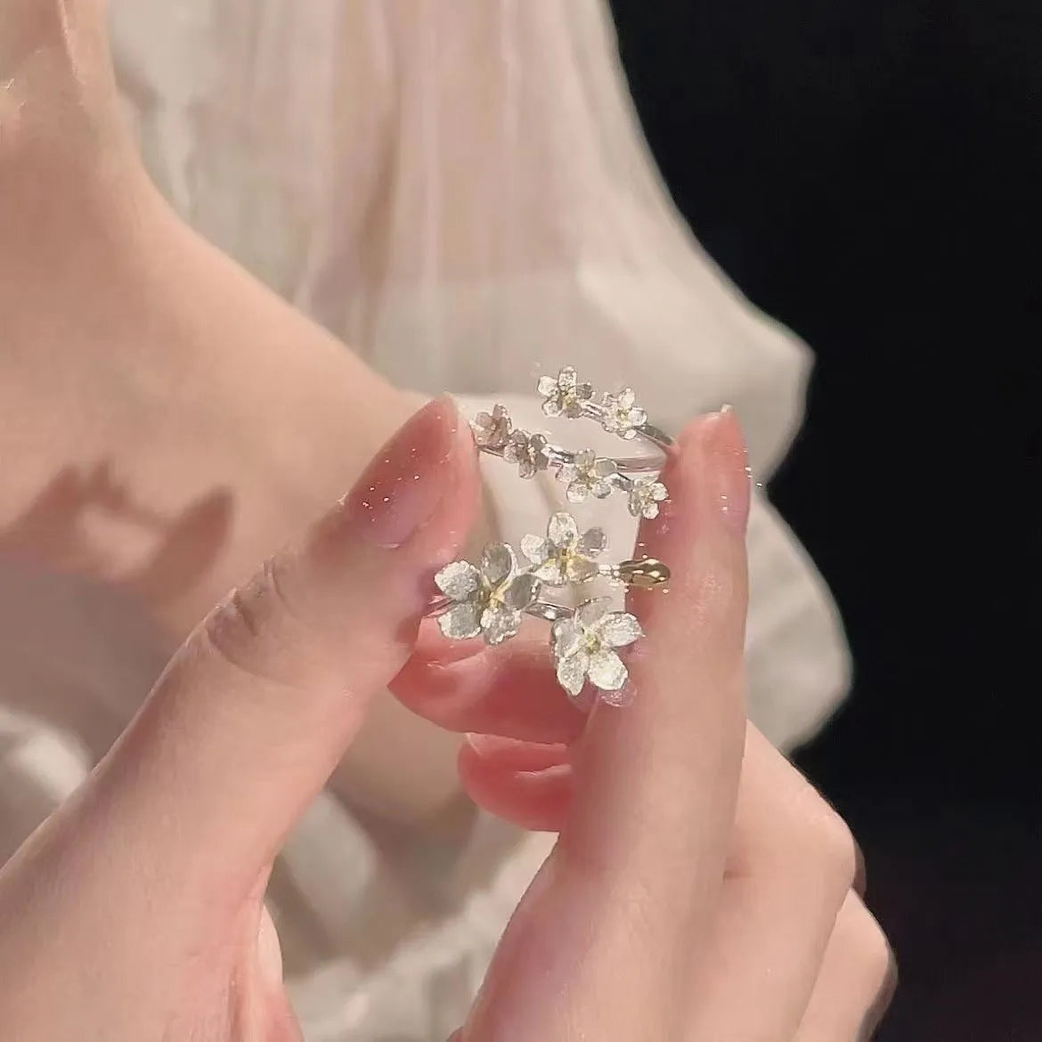 Adjustable open-mouth ring with detailed 3D jasmine flowers, available in three, five, or seven-flower styles.