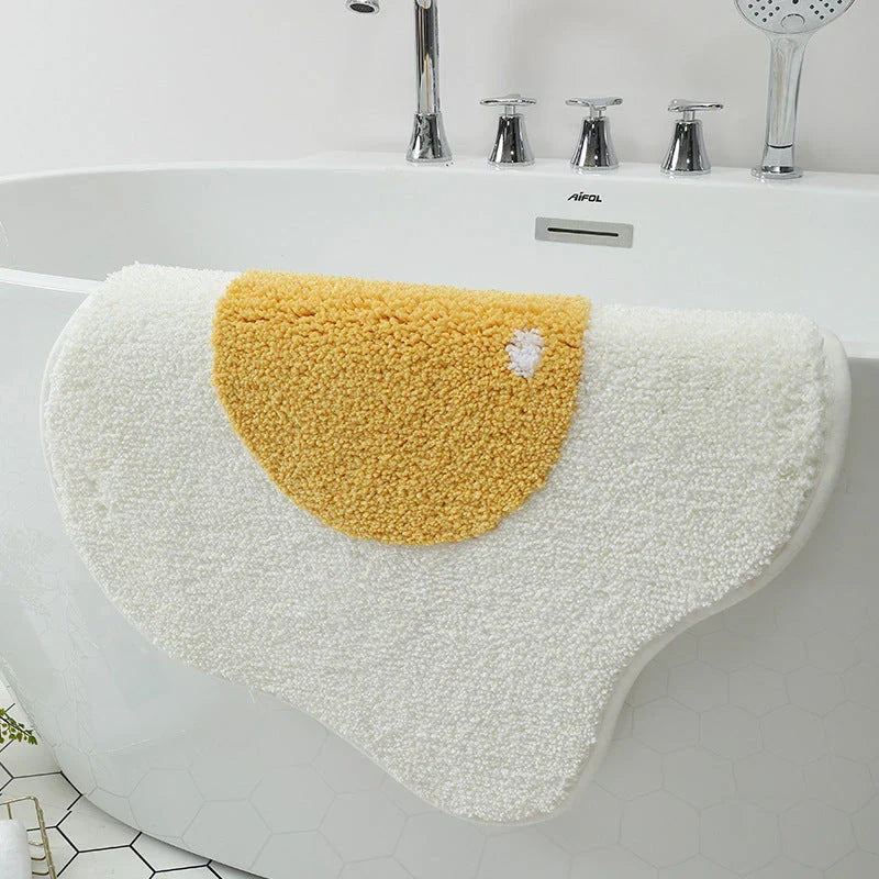 Stylish and absorbent egg-shaped doormat in various sizes and colors, made of plush polyester with a non-slip rubber backing