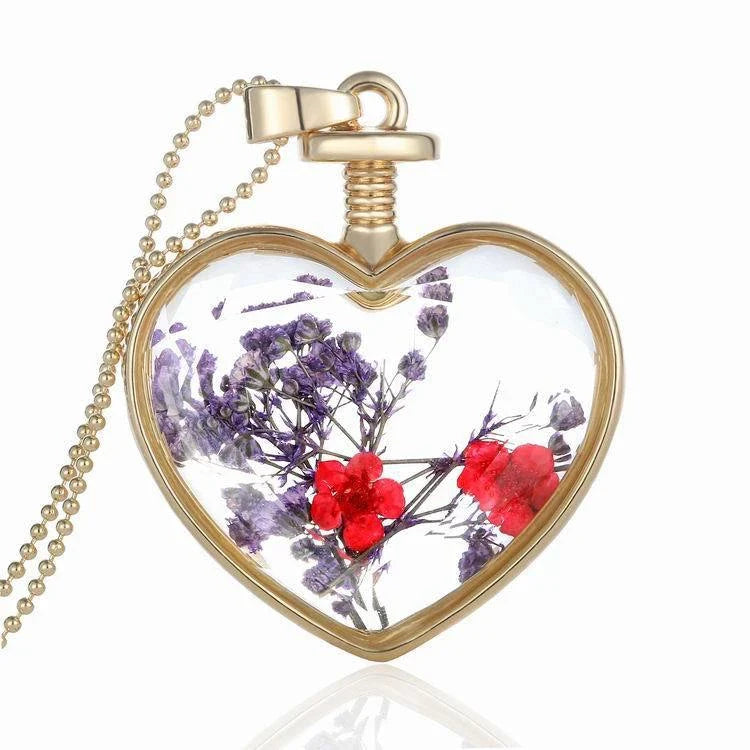 Elegant floral pendant necklace with a dried flower charm on a gold-tone chain