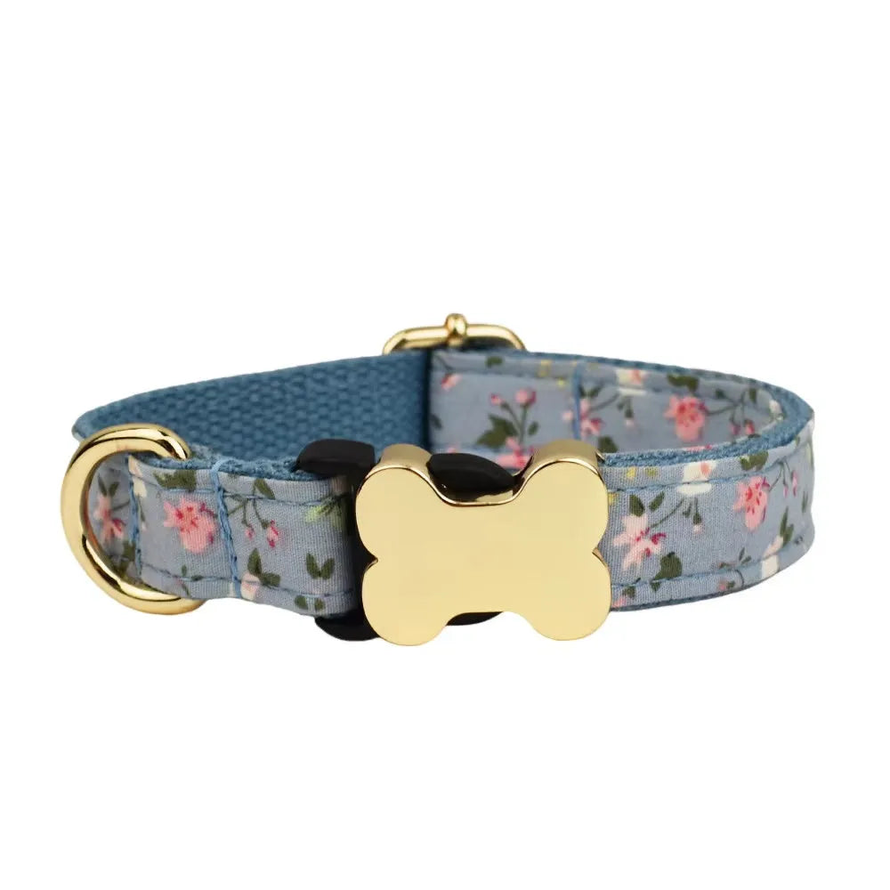 Flat nylon grid print dog collar with a white plastic bone-shaped buckle on a green background.