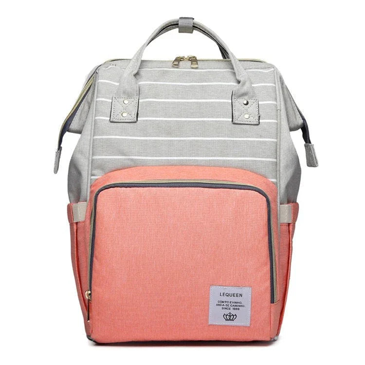 Stylish maternity diaper bag in various colors, featuring a paper bag design, separate bottle compartment, and discreet breastfeeding button.