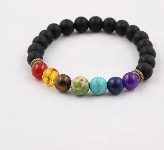 Handcrafted beaded bracelet with seven chakra-representing beads, designed to promote balance and well-being.
