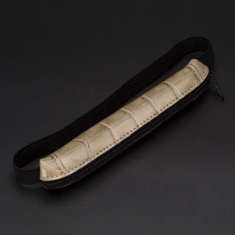 Long beige grey PU leather pencil case on a desk with pens