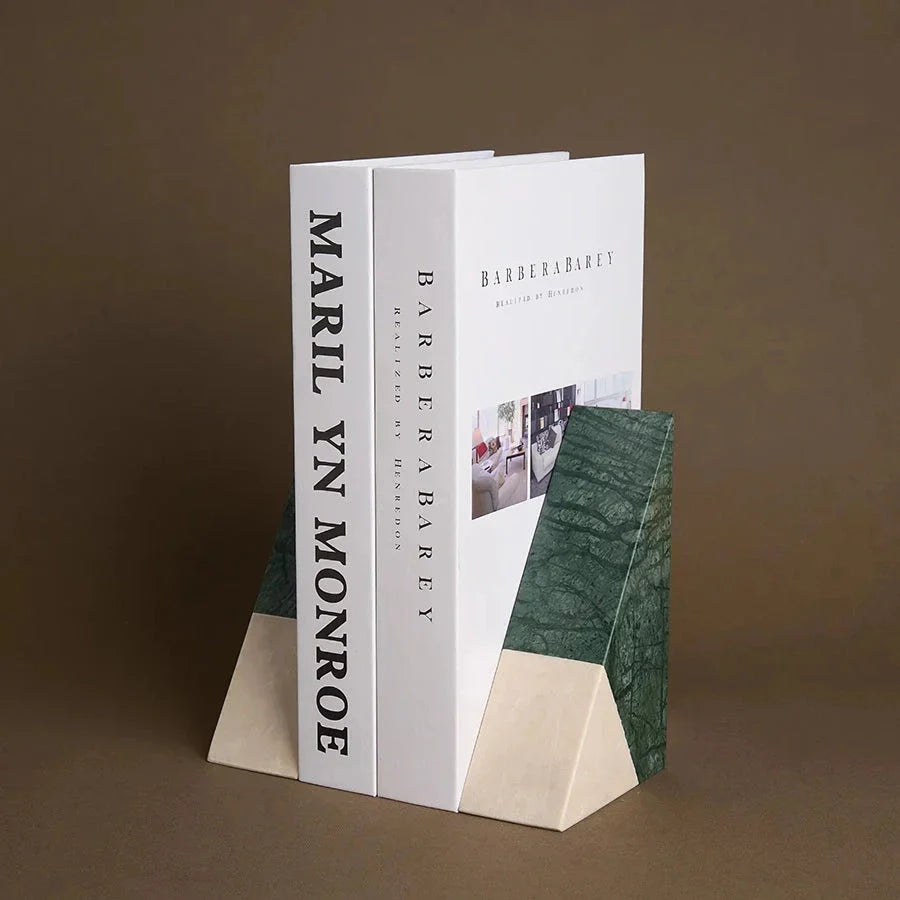 A pair of natural green marble bookends with a retro travertine finish, standing upright and supporting books on a shelf.