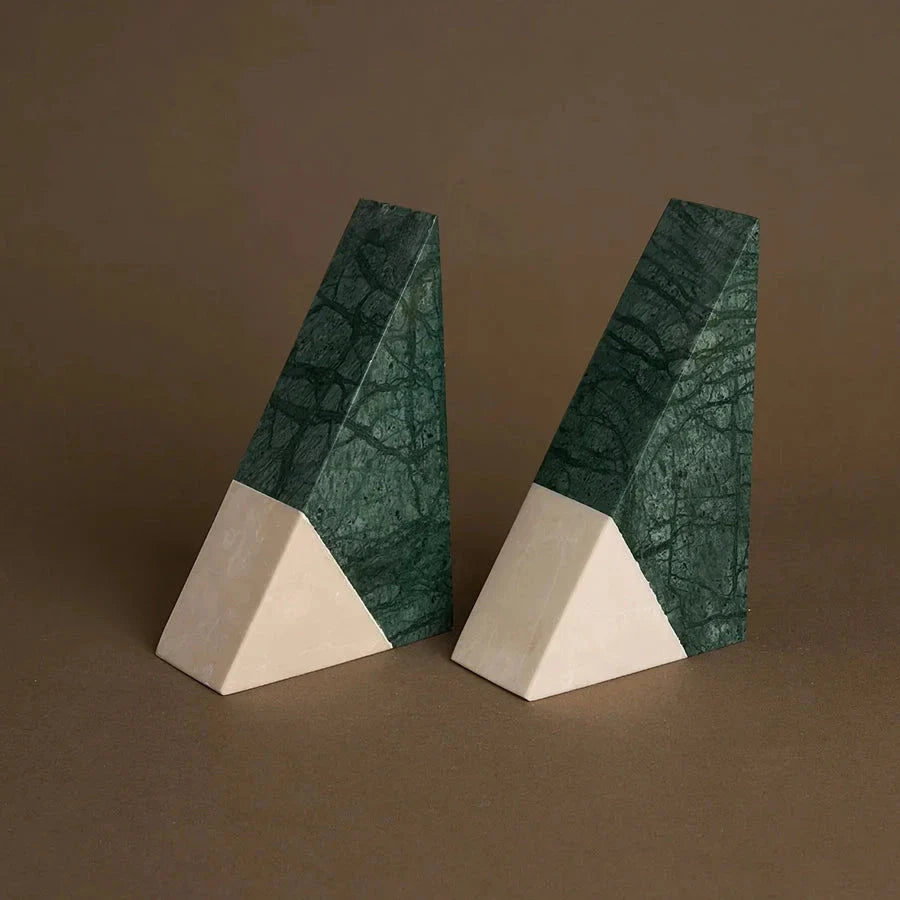 A pair of natural green marble bookends with a retro travertine finish, standing upright and supporting books on a shelf.