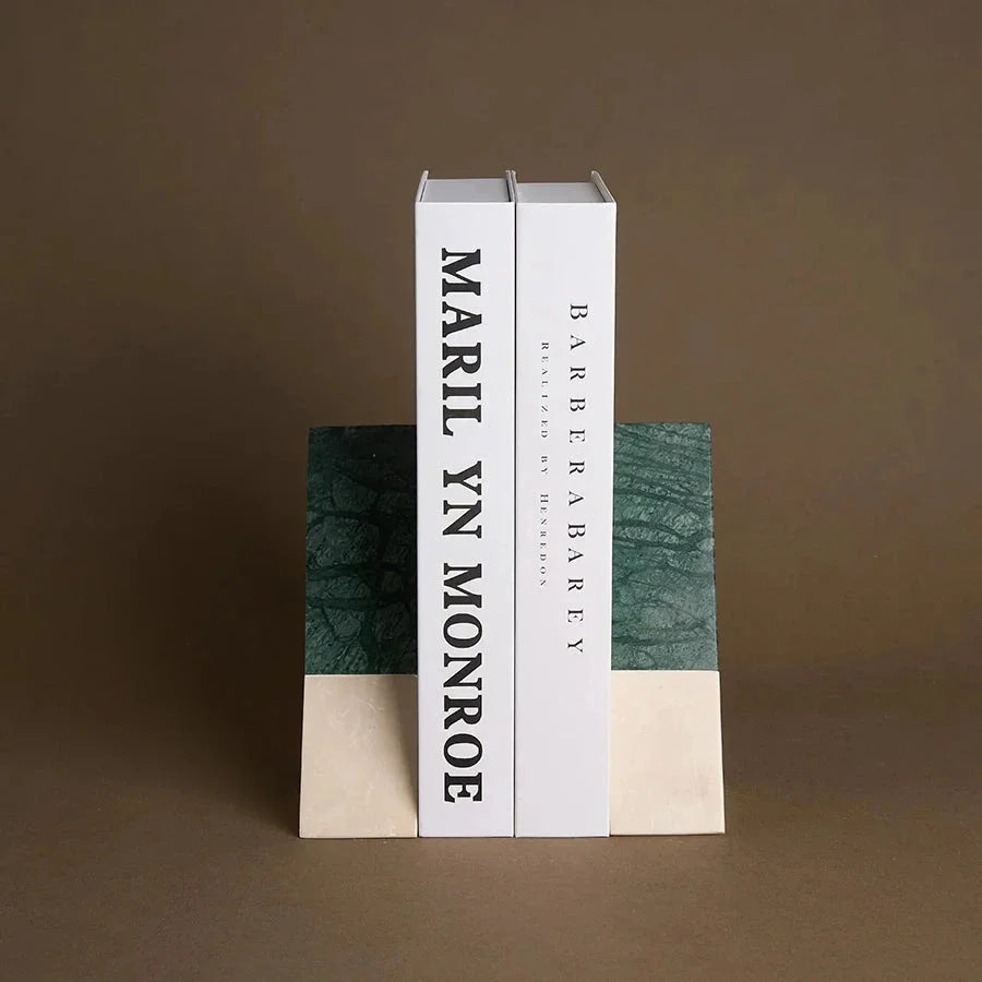 A pair of natural green marble bookends with a retro travertine finish, standing upright and supporting books on a shelf.
