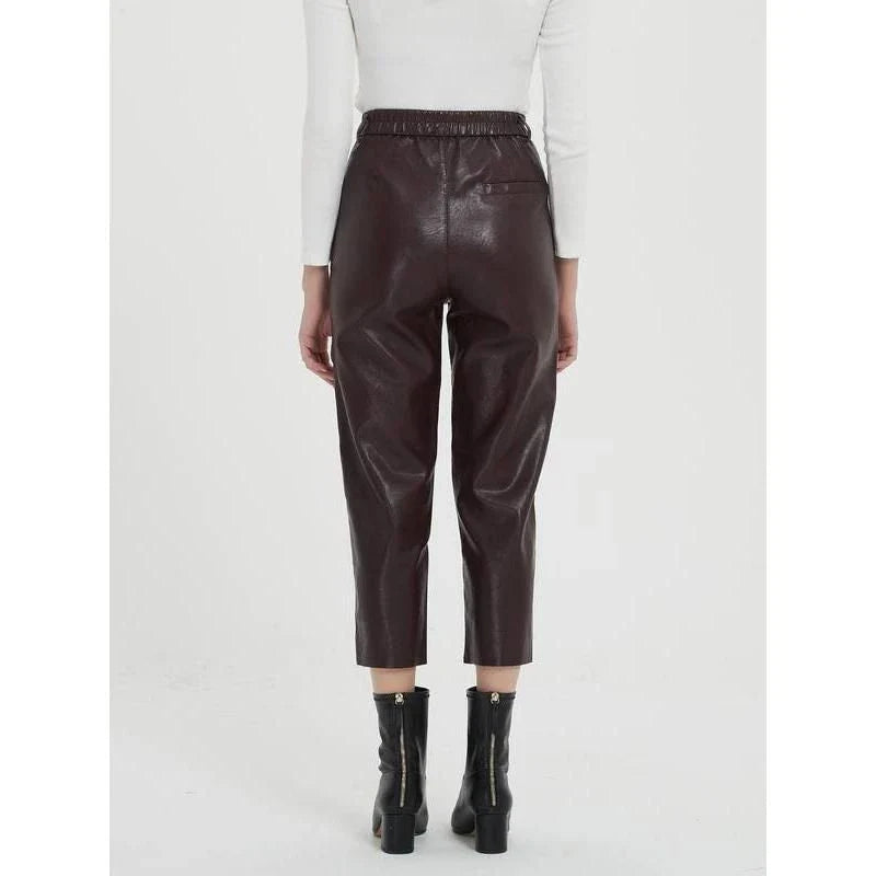 Elegant faux leather pants with high waist and ankle-length design, perfect for office or casual wear.