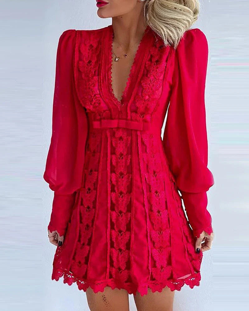 Elegant white lace dress with puff sleeves and butterfly design, perfect for formal occasions and events