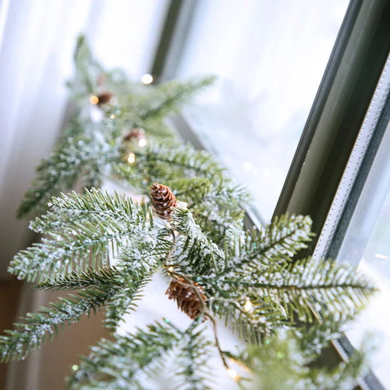 Decorative copper leaf string lights with rattan and pine needle accents, creating a cozy, festive atmosphere