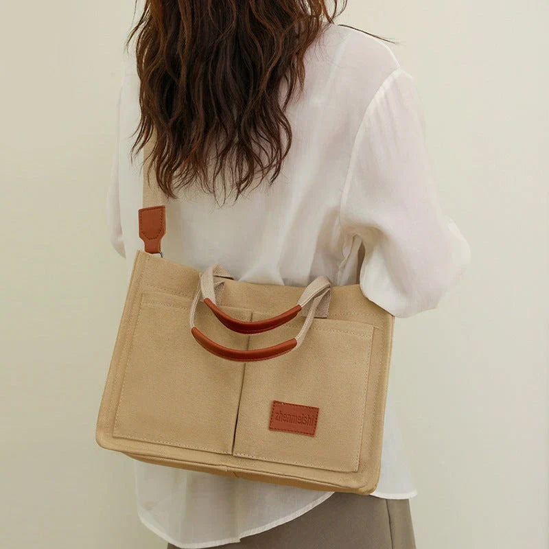 Premium canvas tote bag with multiple pockets, adjustable shoulder strap, and stylish design for everyday use