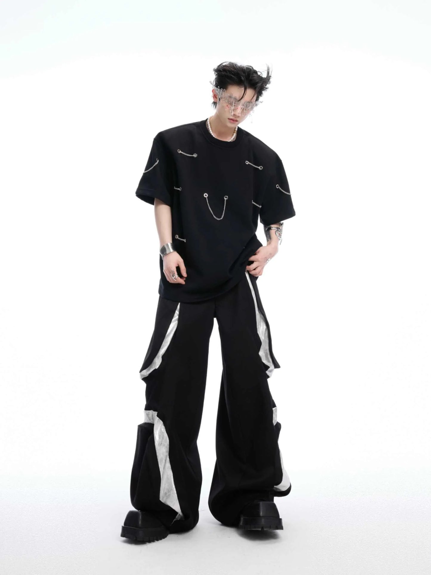 Black men's t-shirt with metal chain and padded shoulder detail on a short sleeve cotton-polyester blend.