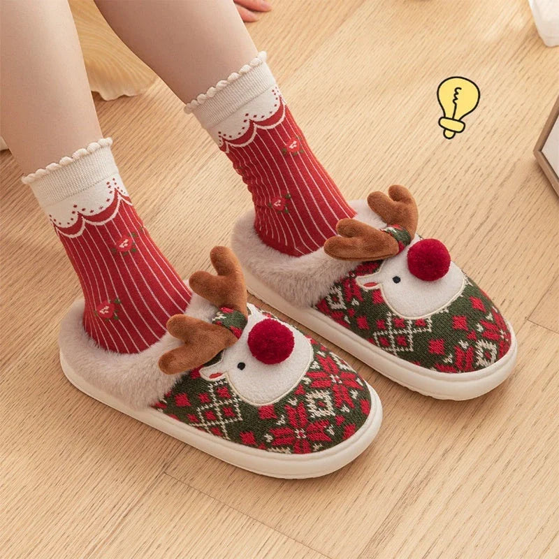 Cozy elk-themed Christmas slippers in green and red colors, featuring a plush, fuzzy design and non-slip sole for comfortable indoor wear