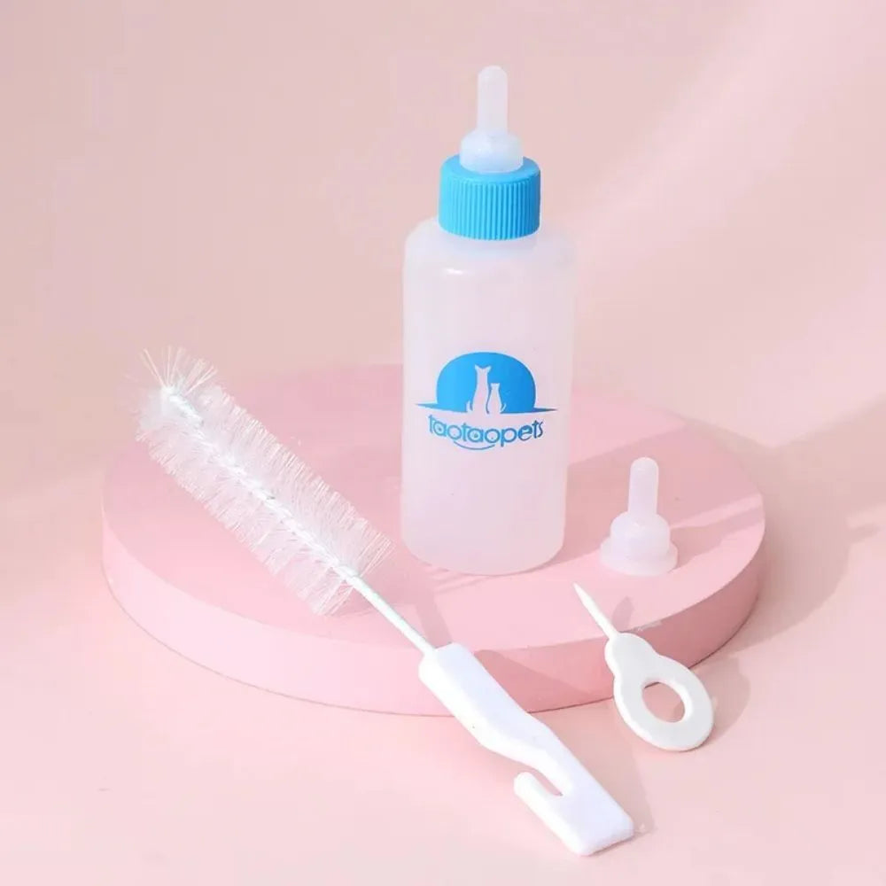 Set of four coloured pet milk bottles with silicone teats and a cleaning brush for small animals.