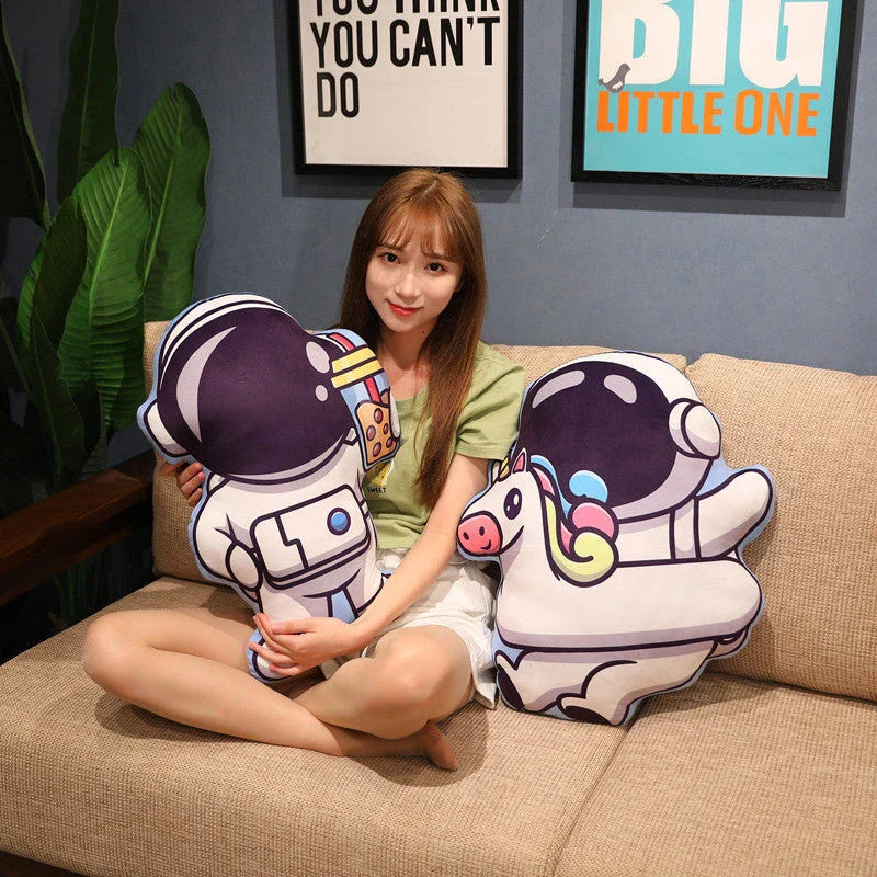 Soft plush astronaut pillows in various space-themed designs, including rockets, spacecraft, and more