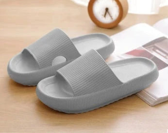 Cozy slip-on slippers in various colors for men and women, featuring soft fabric upper and non-slip EVA soles