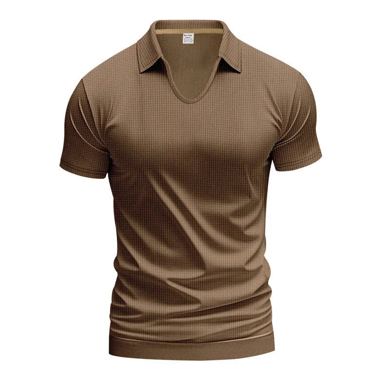 Man modelling a loose-fit apricot coloured V-neck short-sleeve T-shirt for casual summer wear.