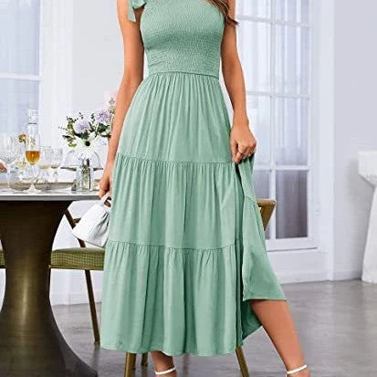 Elegant one-shoulder pleated maxi dress in various colours, featuring an asymmetrical hem and side slits for a stylish, head-turning look