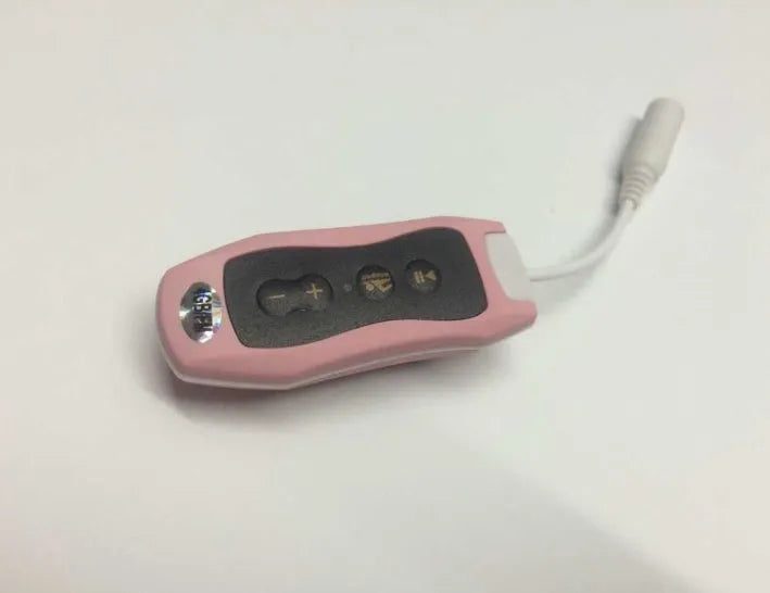 Compact black Bluetooth MP3 headset with clip, shown next to USB charging cable.