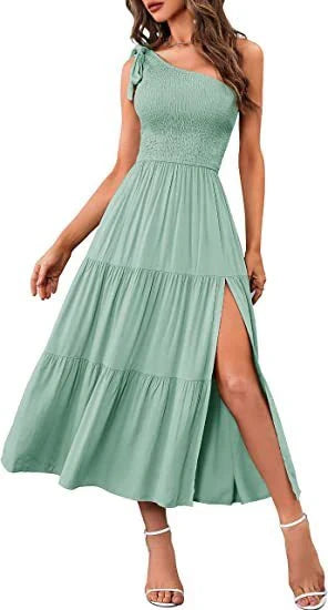 Elegant one-shoulder pleated maxi dress in various colours, featuring an asymmetrical hem and side slits for a stylish, head-turning look