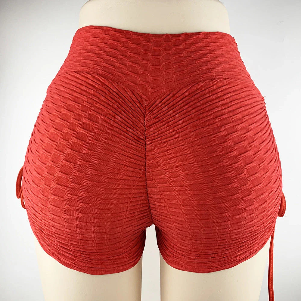 Curve-enhancing workout shorts in a variety of vibrant colors with a drawstring waistband for a customized fit.