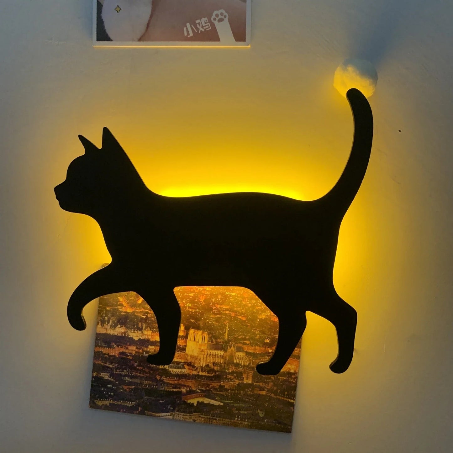 A stylish cat-themed LED lamp that automatically lights up when it detects sound, creating a cozy, ambient glow in a room.