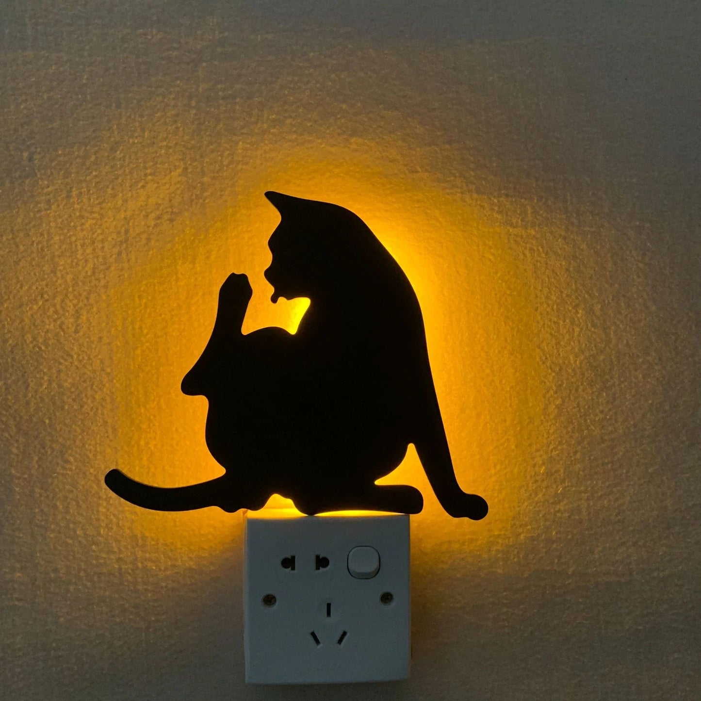 A stylish cat-themed LED lamp that automatically lights up when it detects sound, creating a cozy, ambient glow in a room.
