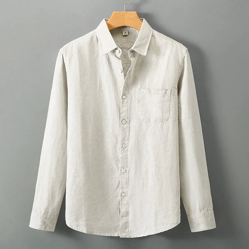 Man wearing a loose-fit light grey long sleeve linen cardigan shirt with a Chinese style design.