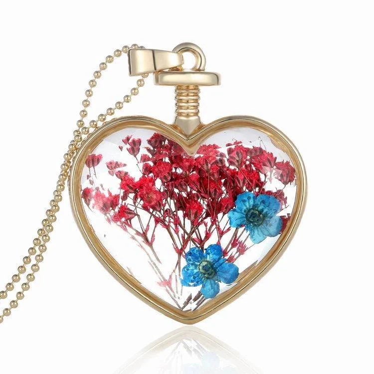 Elegant floral pendant necklace with a dried flower charm on a gold-tone chain