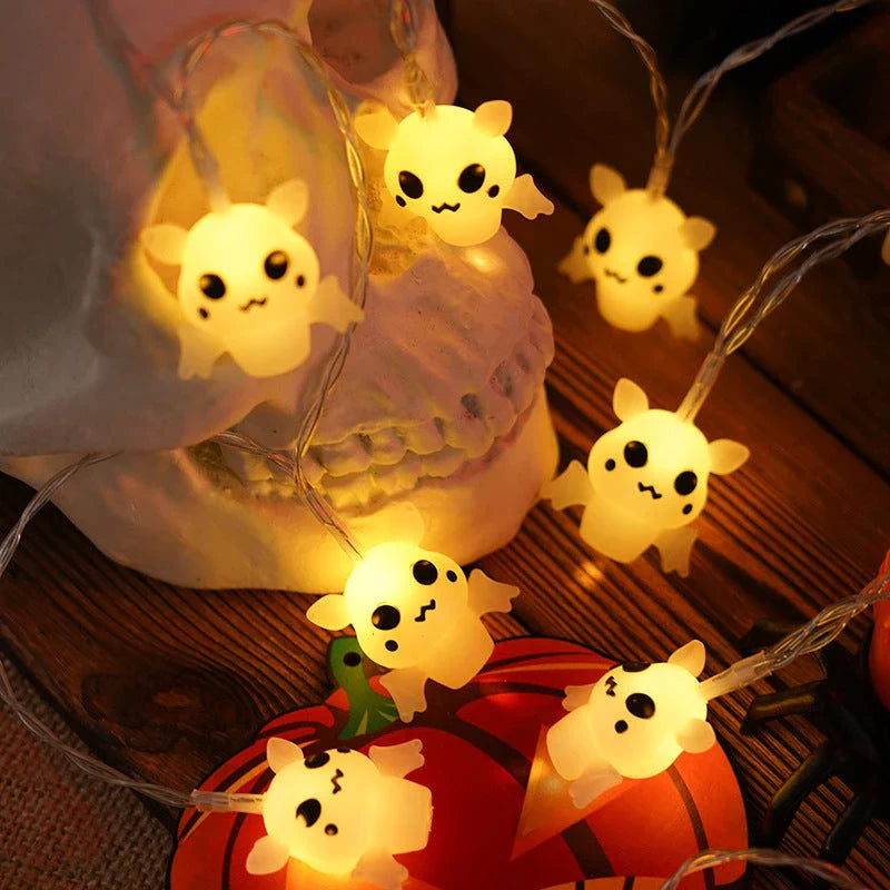 Battery-powered LED Halloween lights in various spooky designs including pumpkins, ghosts, and bats with warm white glow