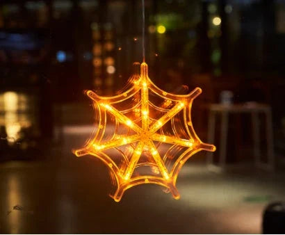 Spooky Halloween window lights featuring ghostly silhouettes, carved pumpkins, and creepy spiders for festive seasonal decor