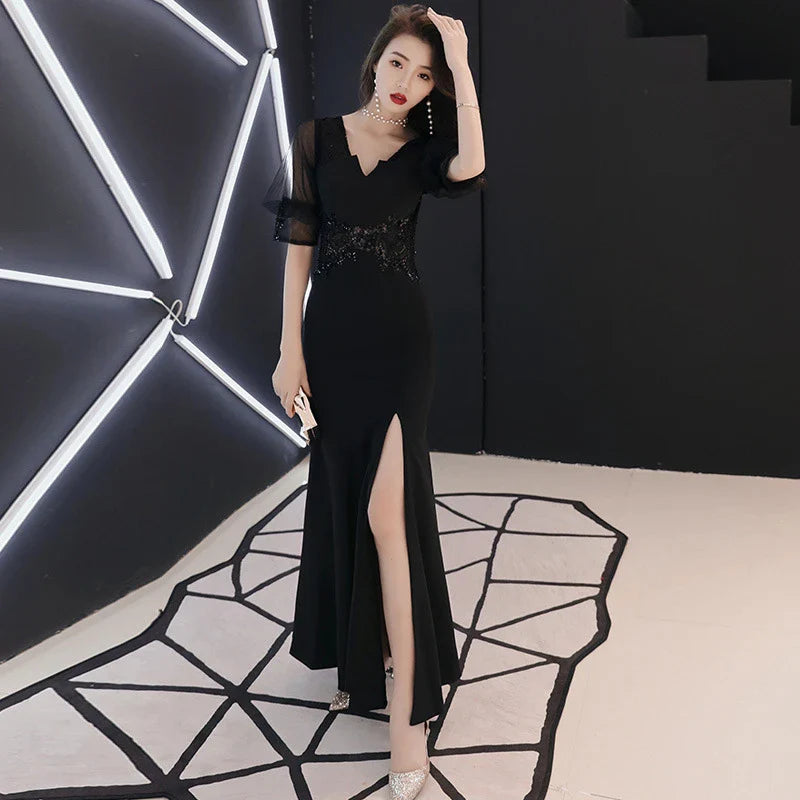 Elegant black evening dress with middle-length sleeves, perfect for formal occasions and red carpet events