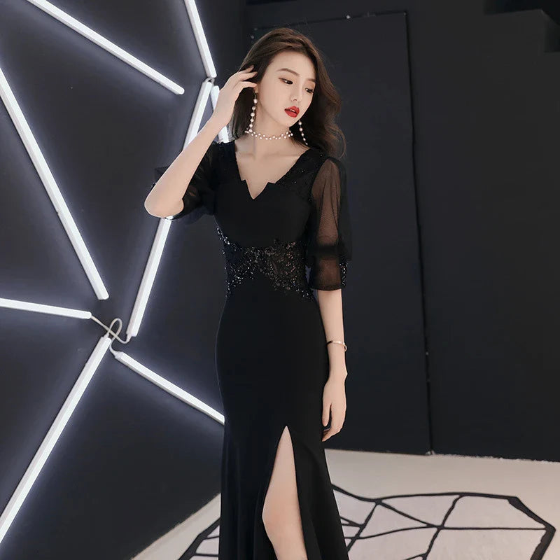 Elegant black evening dress with middle-length sleeves, perfect for formal occasions and red carpet events