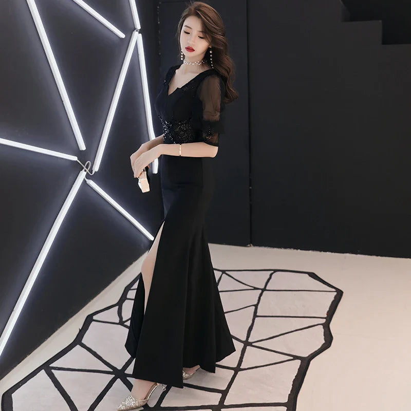 Elegant black evening dress with middle-length sleeves, perfect for formal occasions and red carpet events