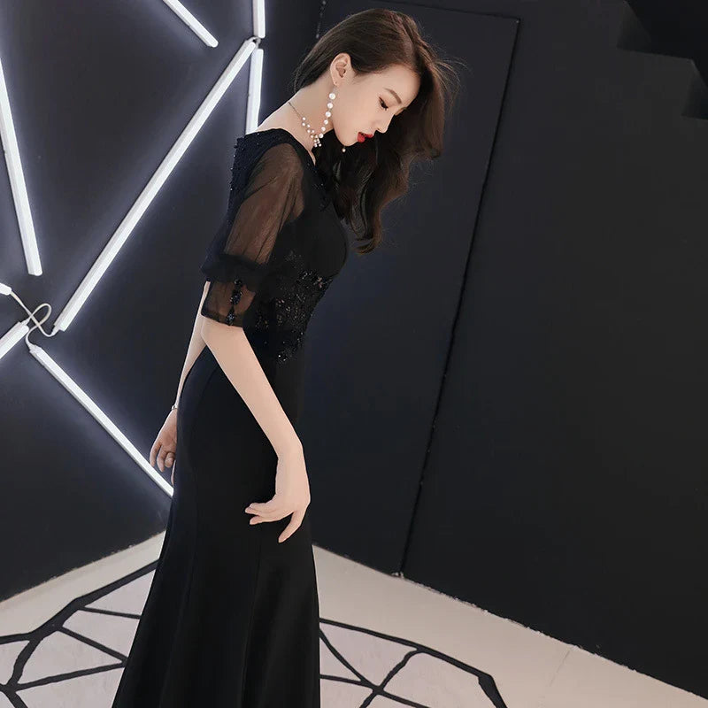 Elegant black evening dress with middle-length sleeves, perfect for formal occasions and red carpet events