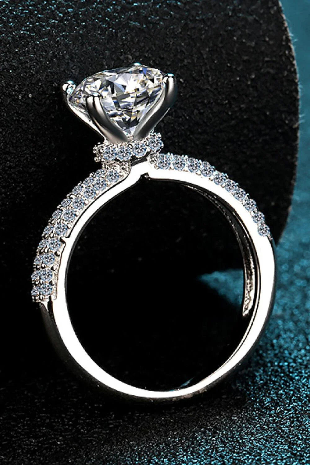 Elegant 4-prong moissanite and sterling silver ring with rhodium plating and zircon accent stones