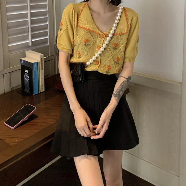 French-inspired short-sleeved cardigan with embroidered details in summer yellow and sky blue colours