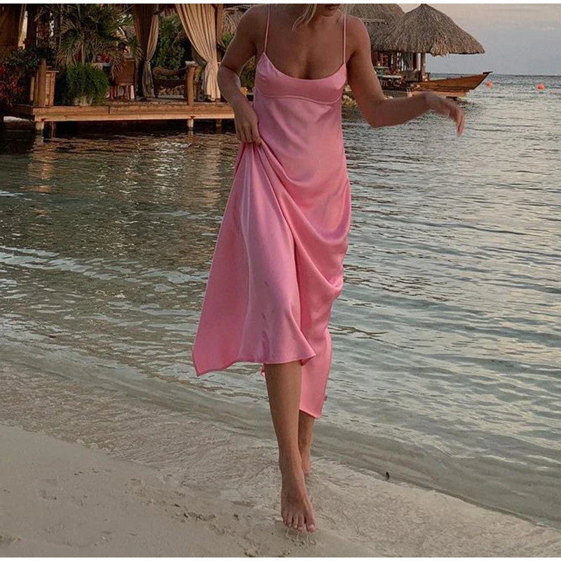 Elegant satin slip dress in pink with a square neckline, sleeveless design, and backless detail