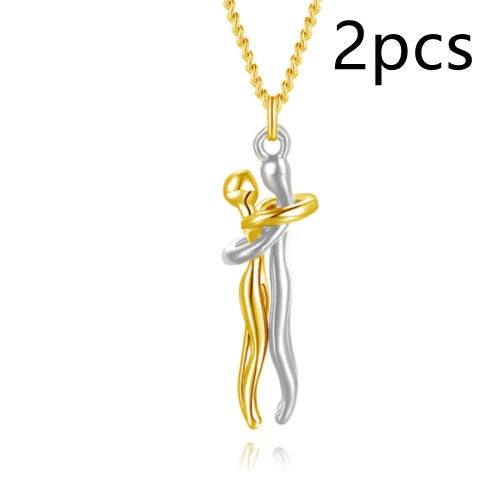Stylish embracing pendant necklace in various colors, including rose gold, white black, black gold, and more. Minimalist design with a delicate chain.