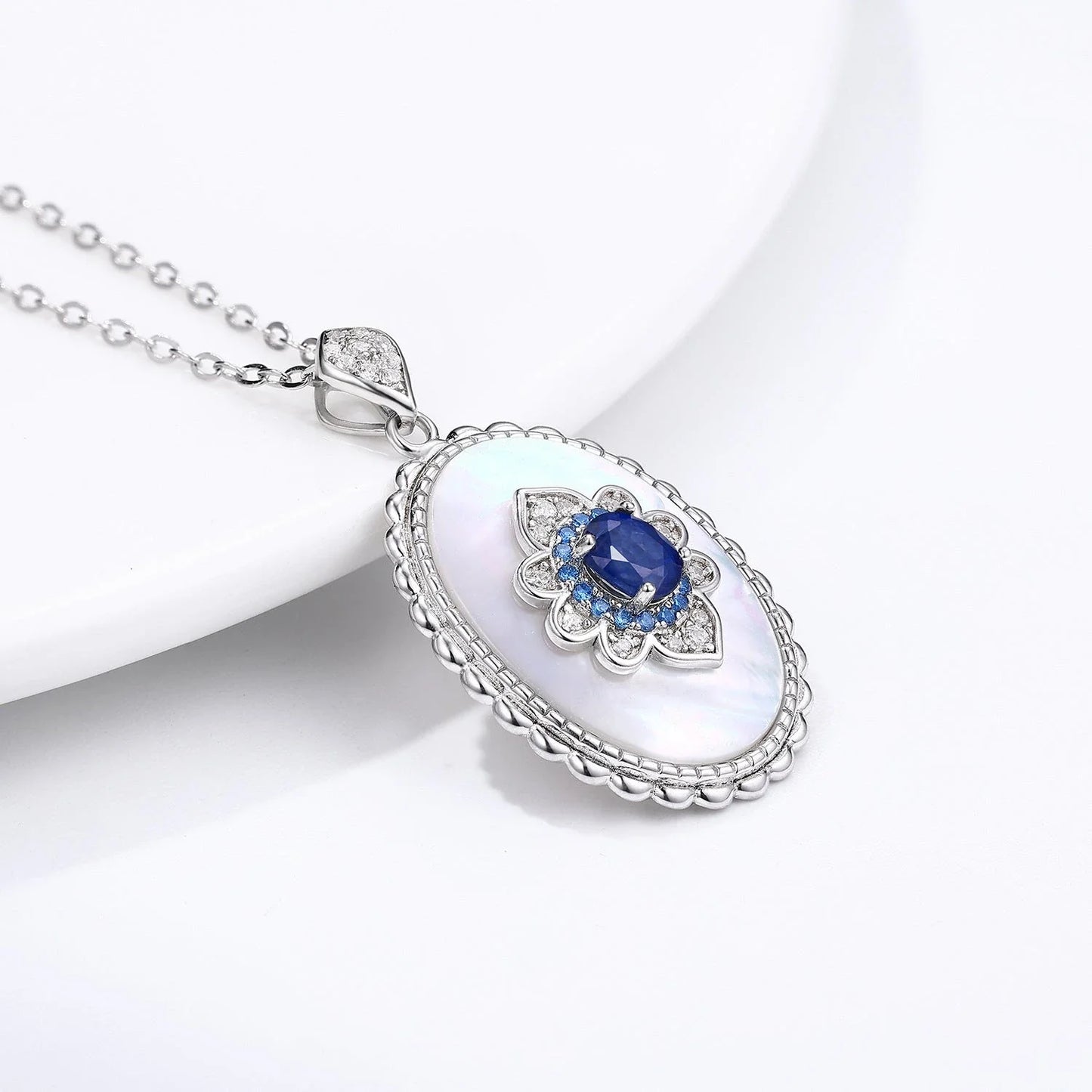 Elegant sapphire and diamond pendant necklace in 925 sterling silver, featuring a sparkling gemstone design and adjustable chain.