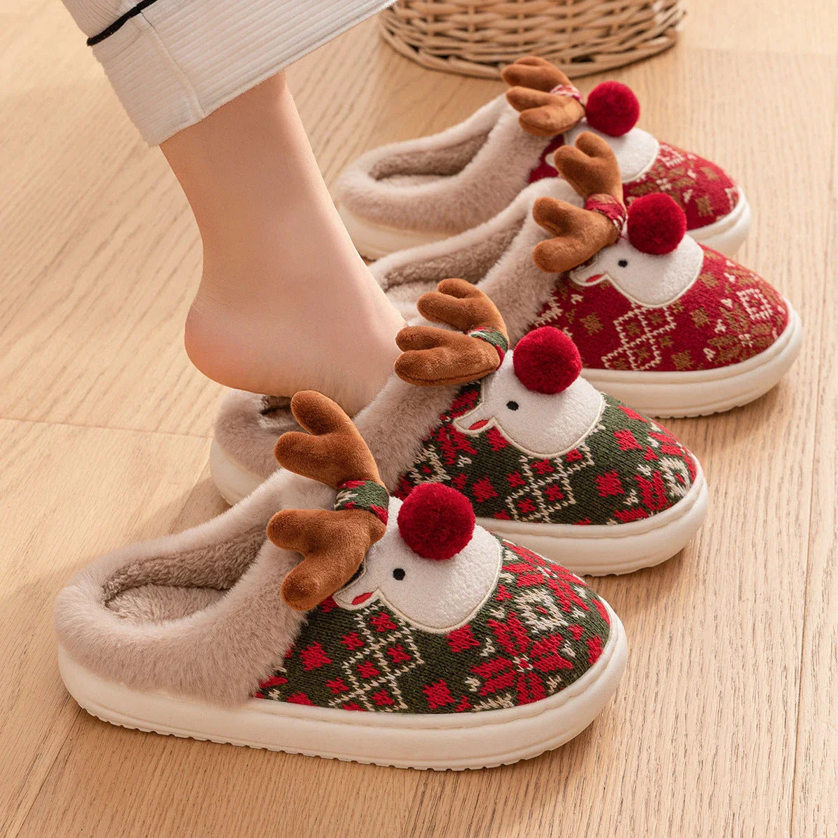 Cozy elk-themed Christmas slippers in green and red colors, featuring a plush, fuzzy design and non-slip sole for comfortable indoor wear