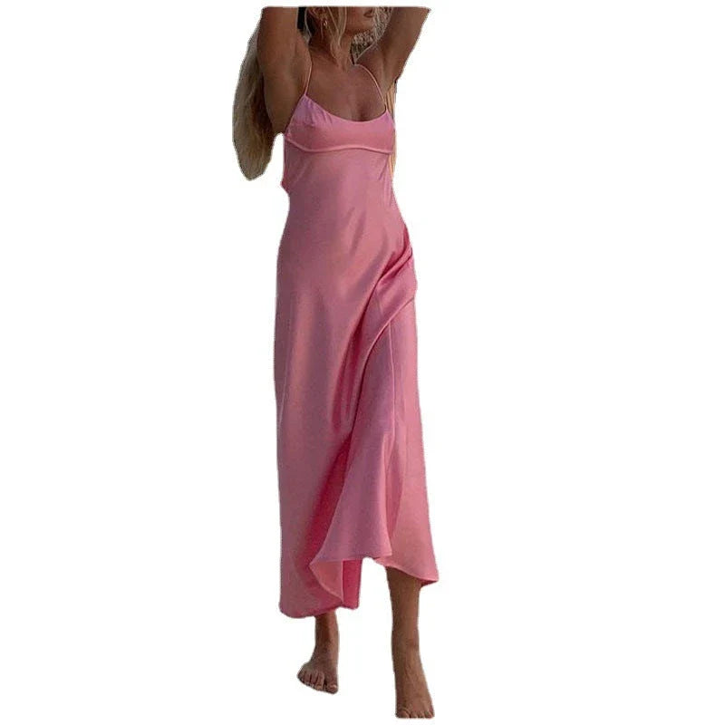 Elegant satin slip dress in pink with a square neckline, sleeveless design, and backless detail