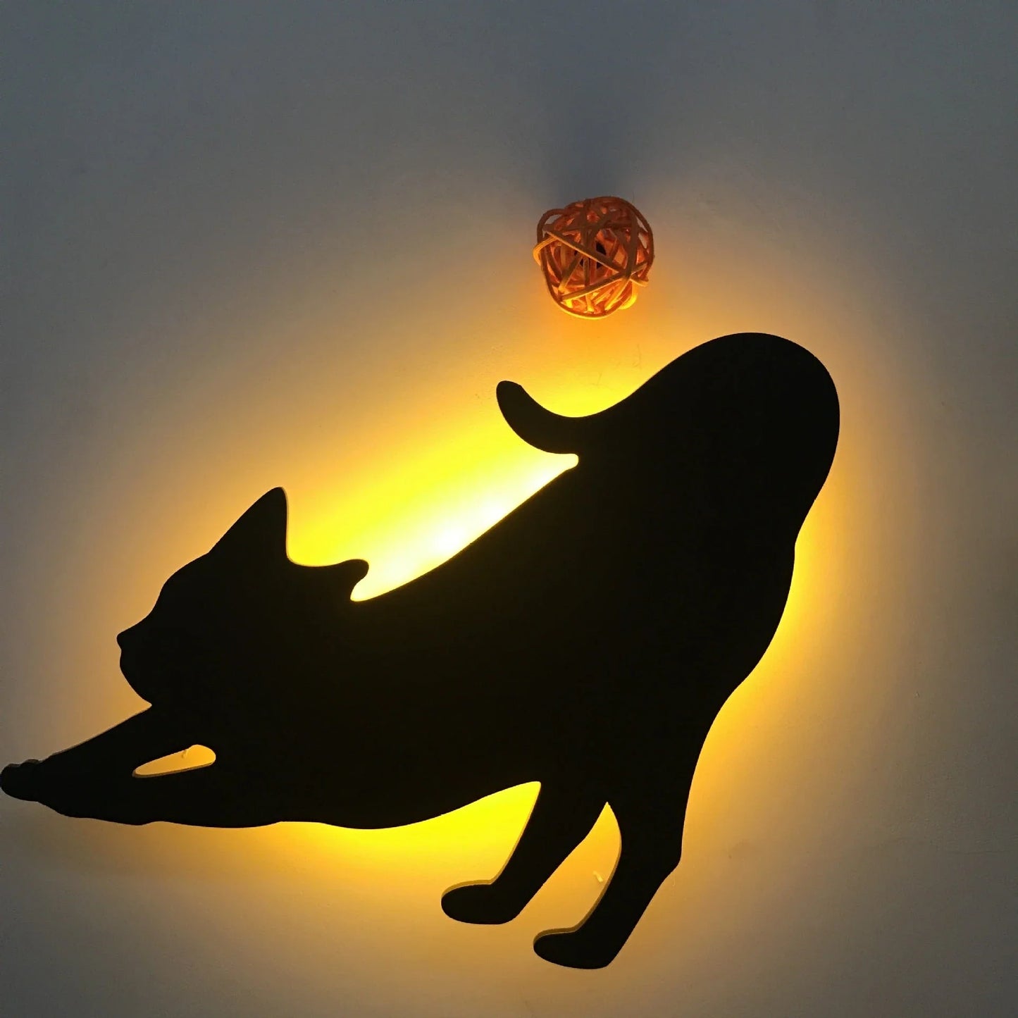 A stylish cat-themed LED lamp that automatically lights up when it detects sound, creating a cozy, ambient glow in a room.