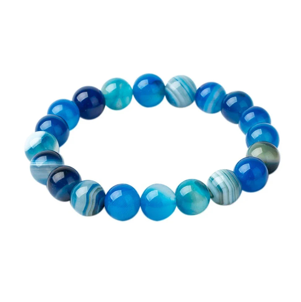 Handcrafted beaded bracelet with seven chakra-representing beads, designed to promote balance and well-being.