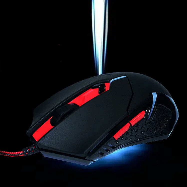 Black and red USB wired optical gaming mouse on a desk with visible buttons and scroll wheel.