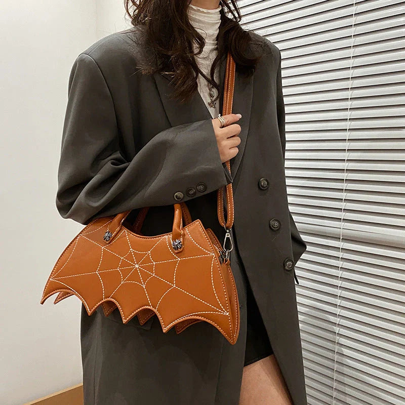 A stylish Halloween shoulder bag with a captivating spider web design, made of durable PU leather and offering ample storage space.