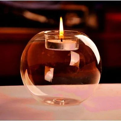 Handmade hollow round glass candle holder in European style on a table.