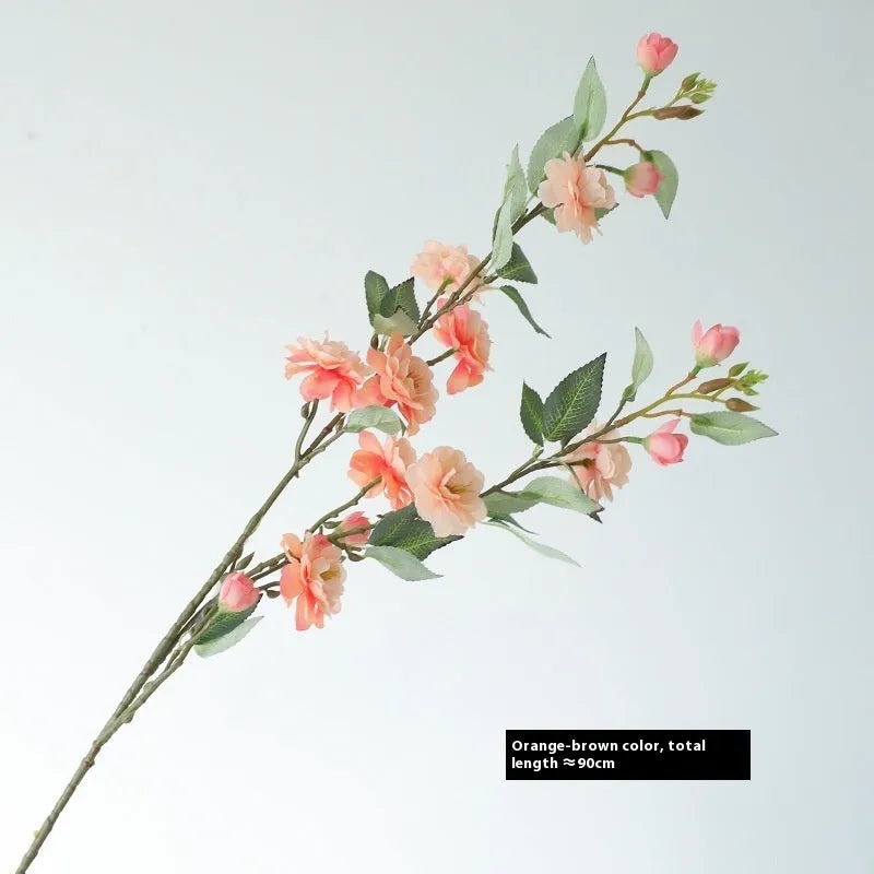 Artificial silk camellia flower in a vase, colours include white, pink, rose pink, and orange coffee.