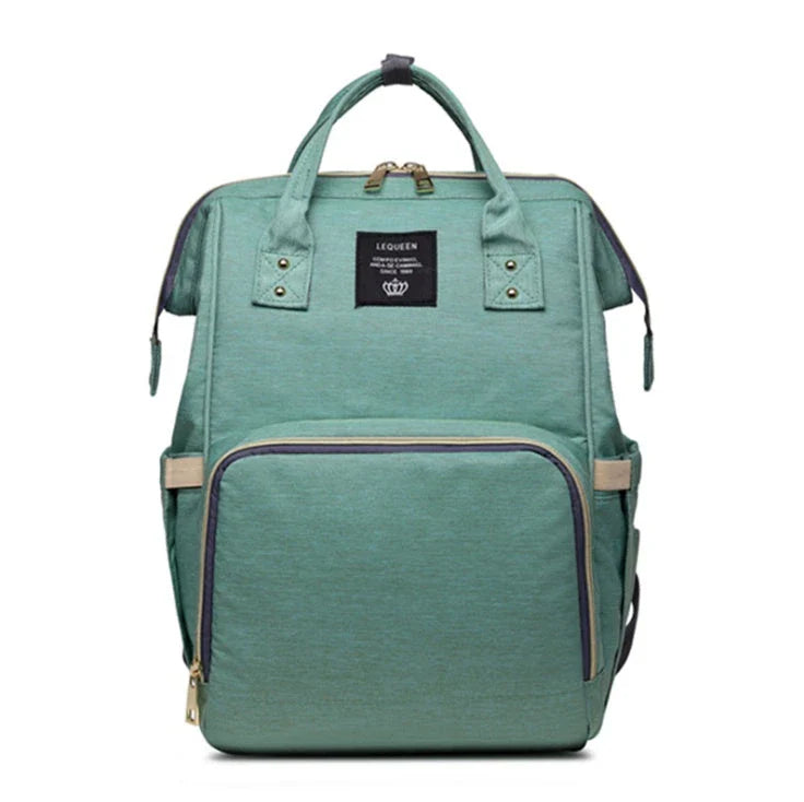 Stylish maternity diaper bag in various colors, featuring a paper bag design, separate bottle compartment, and discreet breastfeeding button.