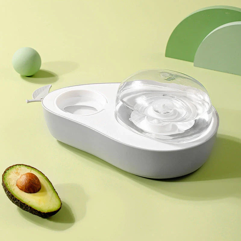 Avocado-shaped automatic pet food and water dispenser for dogs and cats, featuring a raised feeder, slow-feed bowl, and adjustable water flow